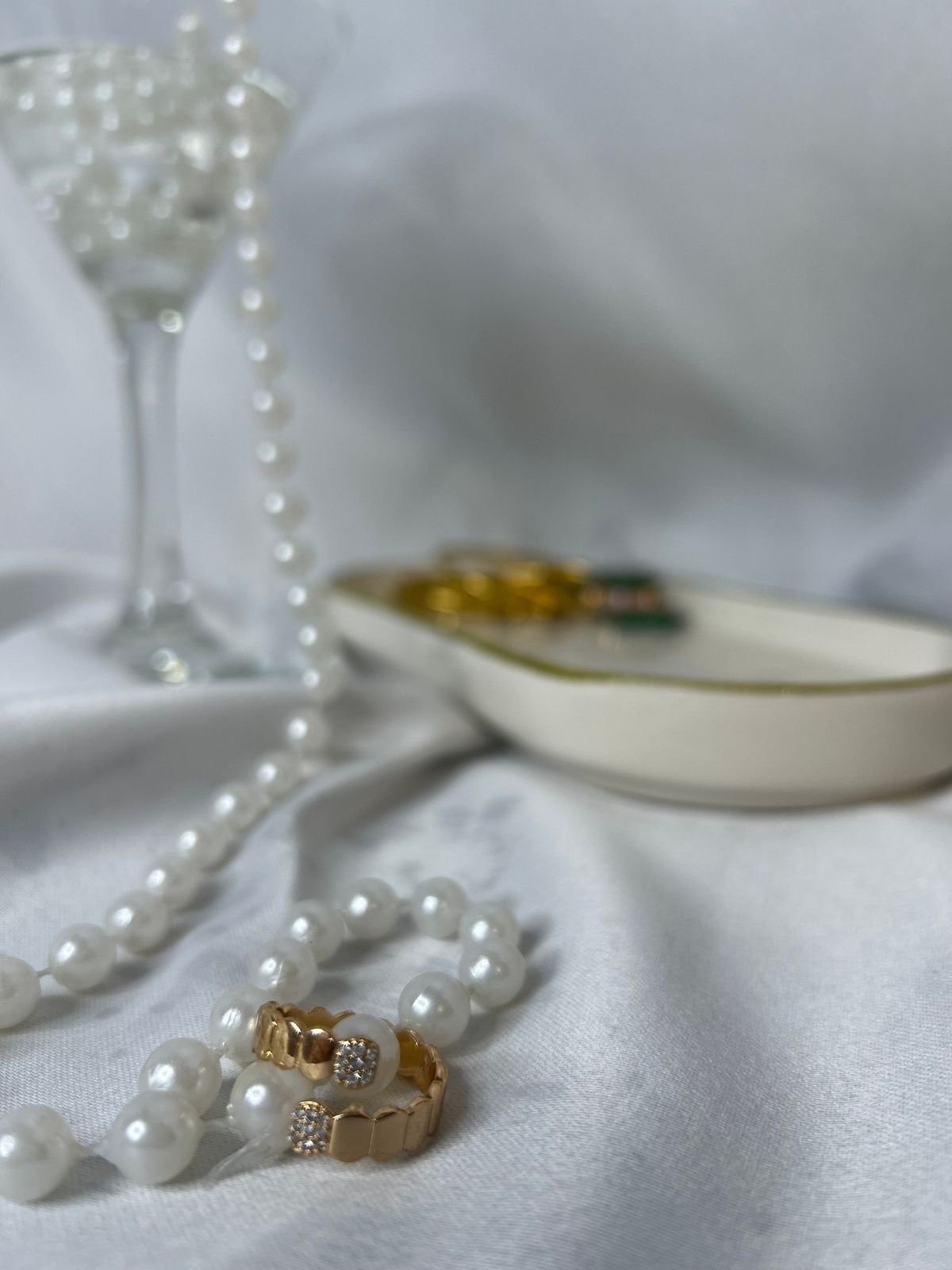 A jewellery gift, chosen with thought — Shreeji Jewellery Gold rings and a pearl necklace displayed on white fabric — Shreeji Jewellery